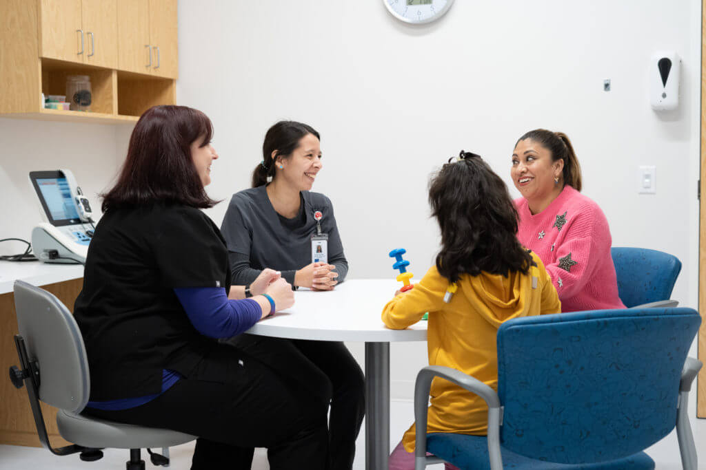 Children with audiologist in examination room